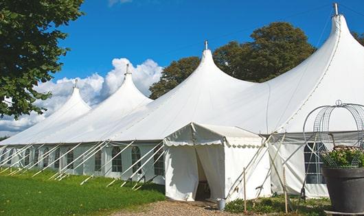 a row of portable restrooms placed outdoors for attendees of a special event in Gilberts